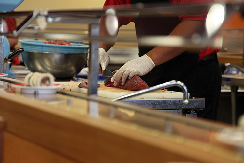 sushi chef slicing fresh tuna
